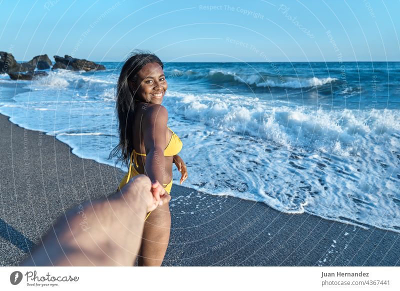 African American woman in love holding her boyfriend hand on the beach pretty african american romance girlfriend romantic relationship valentine husband