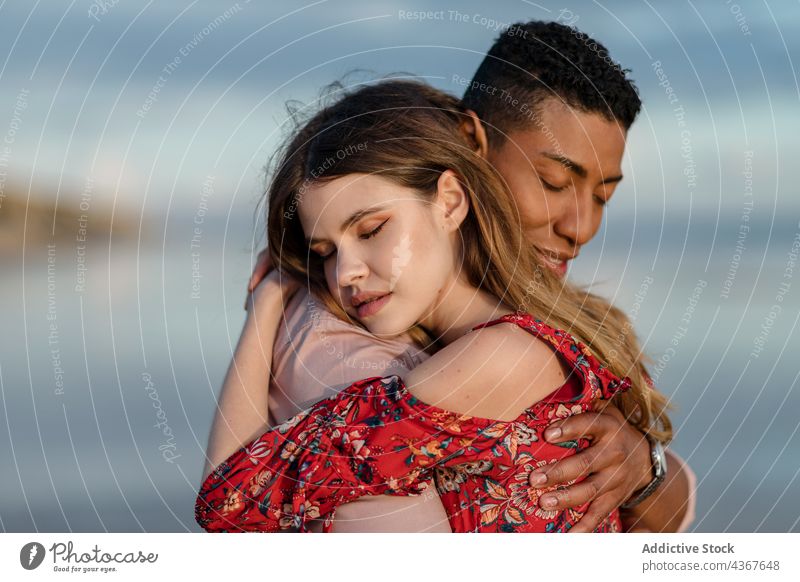 Tender multiethnic couple embracing on beach embrace love seashore tender serene hug relationship multiracial diverse black african american together affection