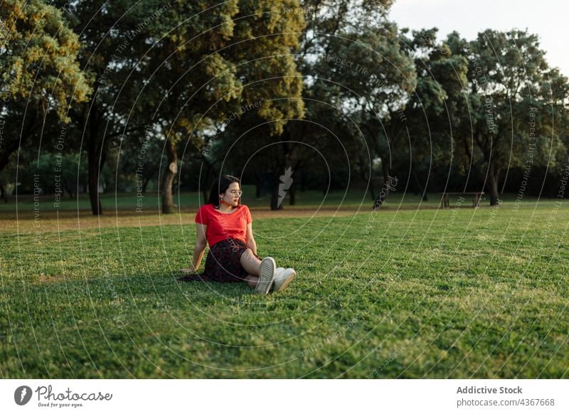 Serene woman chilling on lawn in park summer serene harmony sunset peaceful meadow enjoy female grass nature field sit calm tranquil carefree freedom