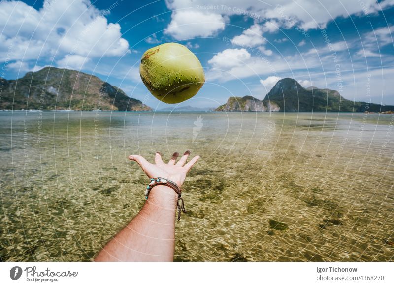 POV Juggling coconut in male hands vs exotic islands in ocean bay palawan Juggle Beach pov destinations Coconut Sky Nido Tropical Hand el Engines vibrations