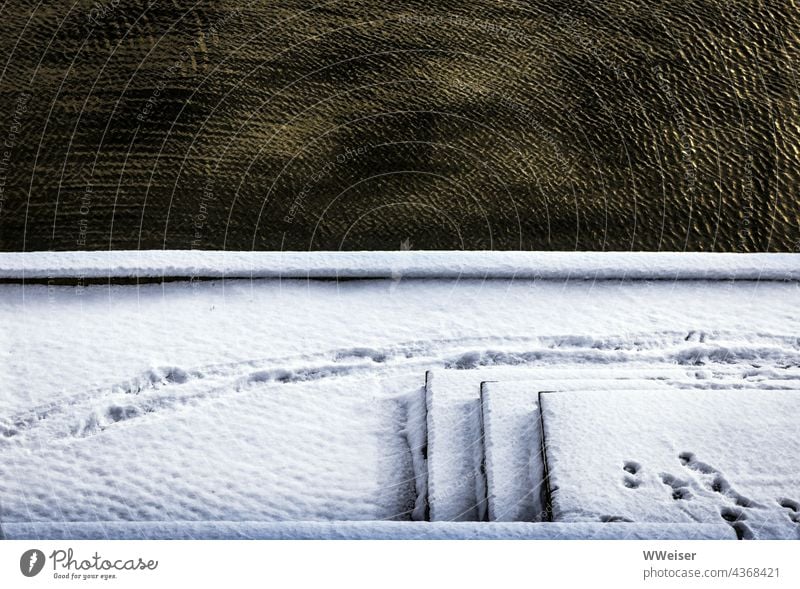 Flowing water with the warm tone of brass and in contrast a staircase, covered with snow and decorated with tracks Snow Winter Cold Ice Water Freeze Frozen