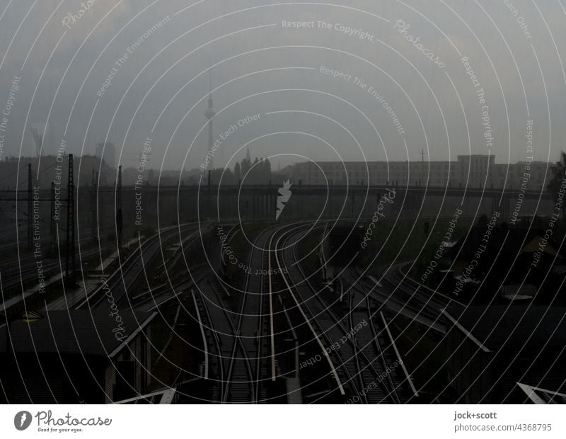 Berlin television tower in heavy rain on a summer day Railroad system Commuter trains Bridge Berlin TV Tower Landmark Silhouette Train station