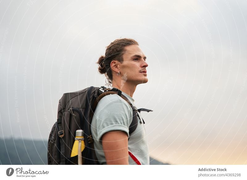 Male hiker standing on rock above sea man viewpoint admire travel trekking summer adventure male trip nature observe edge traveler journey enjoy rocky majestic