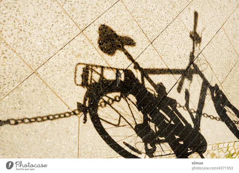 Shadow of a man's bicycle and a barrier chain on a sidewalk / cycling Bicycle Chain off Footpath cordon Saddle Wheel rod Parking be mobile Lanes & trails