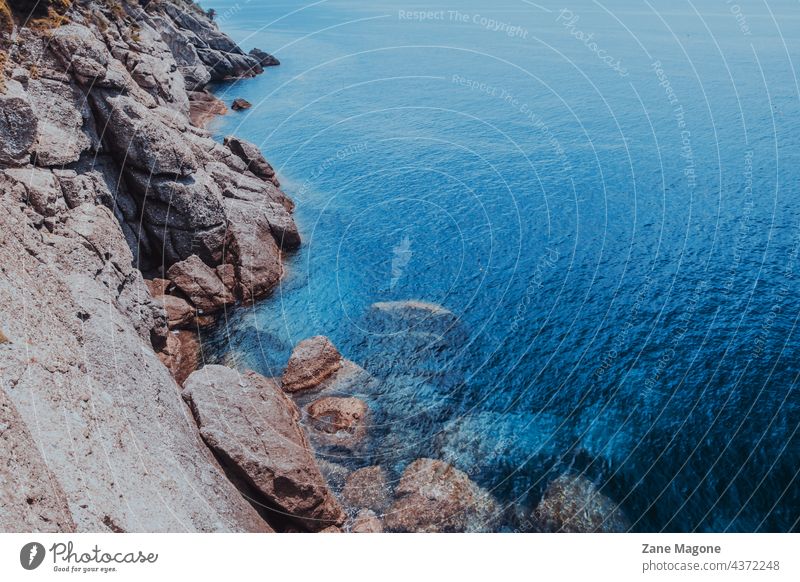 Saturated dark blue sea and rocky cliffs rocks italy Portofino saturated blue seaside shore beaches italy beach italy coast coastline large rocks