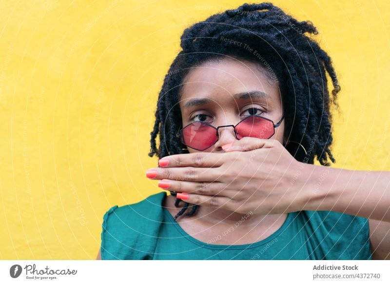 Woman covering her mouth with her hand beauty african model people american afro ethnic curly mixed woman female portrait black pretty surprised person