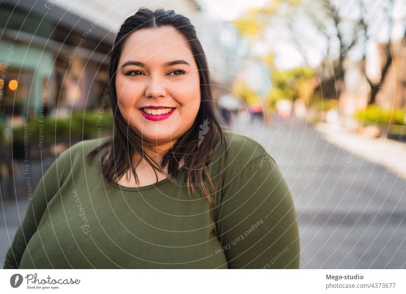 Portrait of young plus size woman. people adult street female urban person city style pretty beauty happy one beautiful lady outdoors close closeup attractive