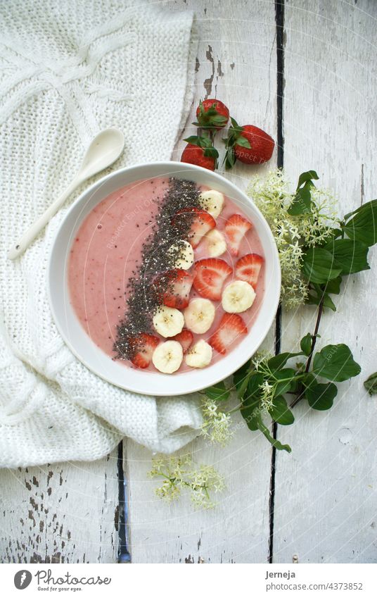 Strawberry smoothie bowl with chia seeds, cut strawberries and banana sweet health healthy food Vegetarian diet Diet Bowl Summer Fresh Pink Red White background