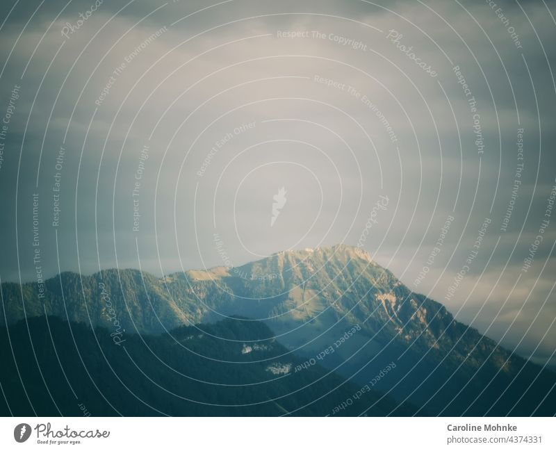 The evening sun puts the Stanserhorn in a mysterious light mountains Evening Evening sun Switzerland Mountain Dusk Sunset Blue Clouds Nature Twilight