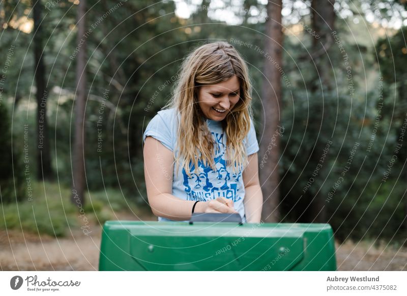 woman cooking at a camp stove in the forest baby blonde california camper camping campsite caucasian chair child childhood daughter family fire fun girl happy