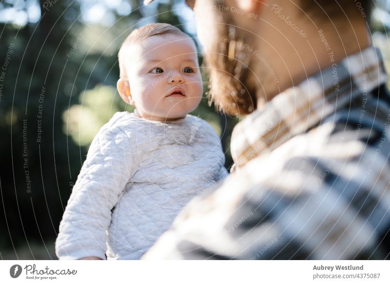 baby girl looking at her father's face 25-30 30-35 30-40 beard bonding california camp camper camping campsite caucasian chair child childhood dad daddy