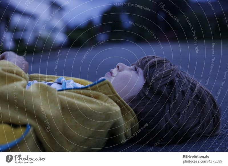 Child lying on the ground in the evening light happy child naturally Boy (child) Head Infancy 3 - 8 years Exterior shot To enjoy Authentic portrait Human being