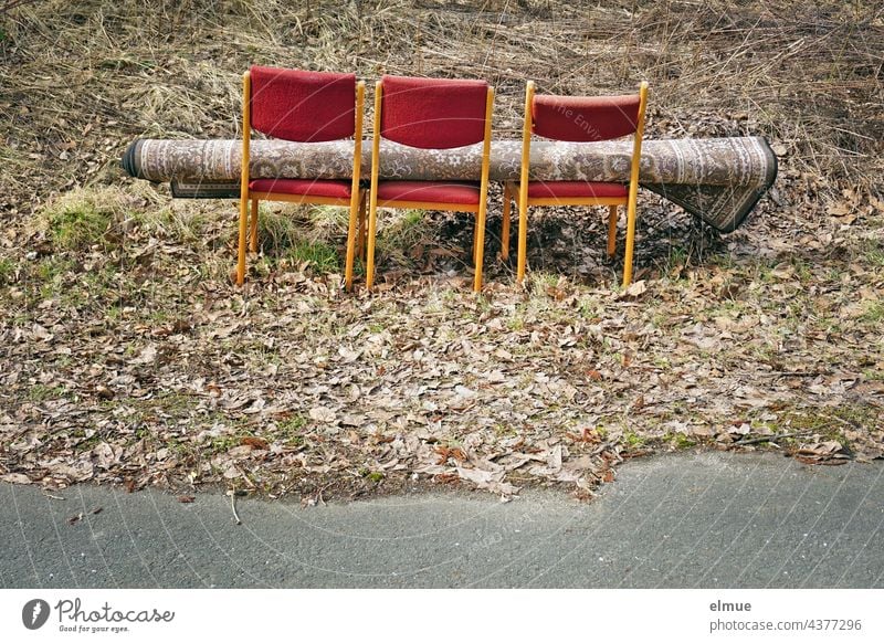 three chairs and a carpet lying on them in the middle of nature next to a road / illegal waste disposal Waste management illegal garbage disposal illicit Carpet