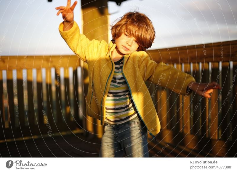 Child dancing in the sunlight Sunset Landscape Above wide Lookout tower Hair and hairstyles Blonde Colour photo Far-off places Nature portrait Authentic