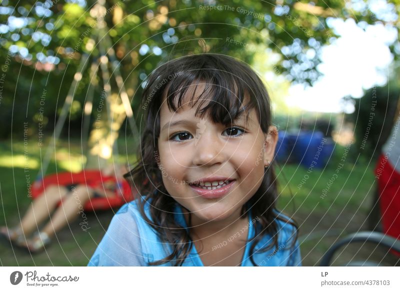 girl having a great time smiling and looking at the camera pursuit of happiness pursuit - concept positive emotion Playful people multi colored baloons