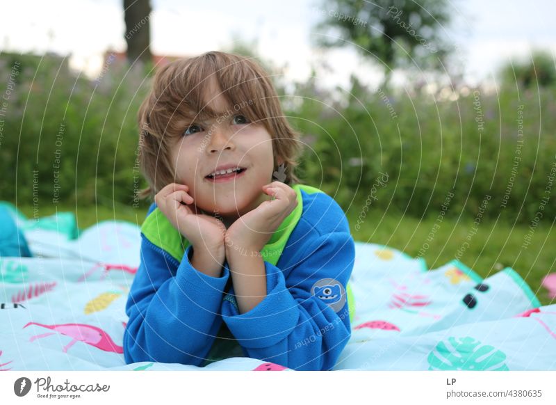 boy having a great time smiling and looking at the camera pursuit of happiness pursuit - concept positive emotion Playful people multi colored baloons