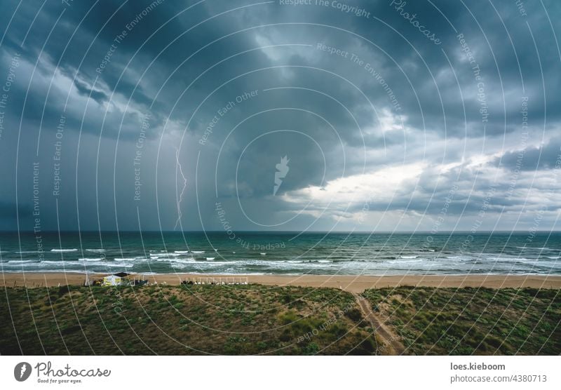 Lightning flash and thunderstorm over the ocean along the Mediterranean coast in Daimus, Spain lightning weather beach thunderbolt sea water summer nature sky