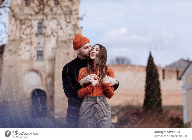 in love stylish young couple kissing in the city. Fashion outdoor sensual romantic portrait of beautiful young couple hugs and kissing on the city. selective focus