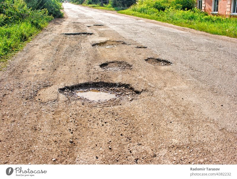 old broken road in the village construction asphalt street ground dirty damage danger hole highway travel pothole rough black background lane crack texture