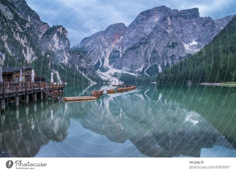 a morning at the Pragser Wildsee Prags Wildsee Lake mountain lake reflection Reflection Boathouse boats Rowboats Mountain lake mountains Vacation & Travel