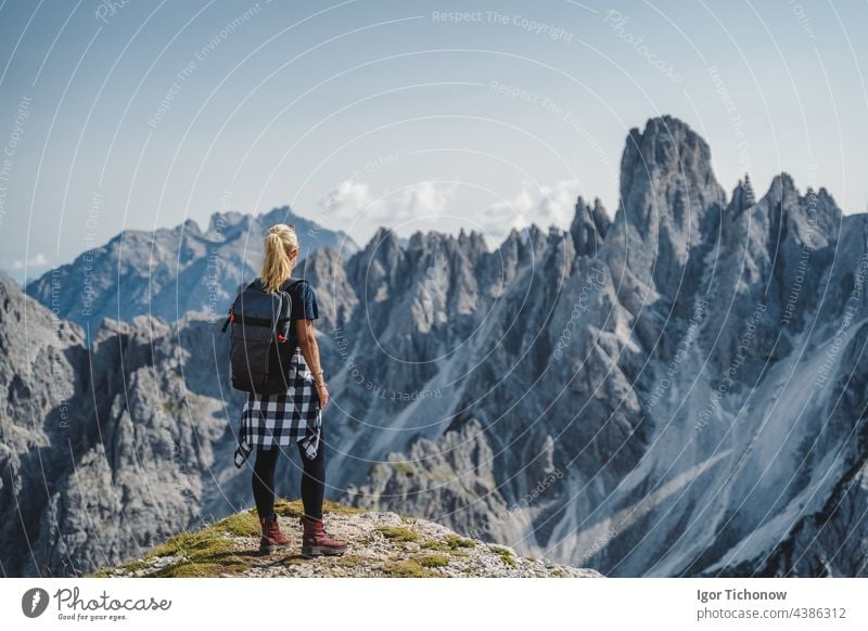 Woman hiker with backpack against Cadini di Misurina mountain group range of Italian Alps, Dolomites, Italy, Europe dolomites women cadini mountains amazing