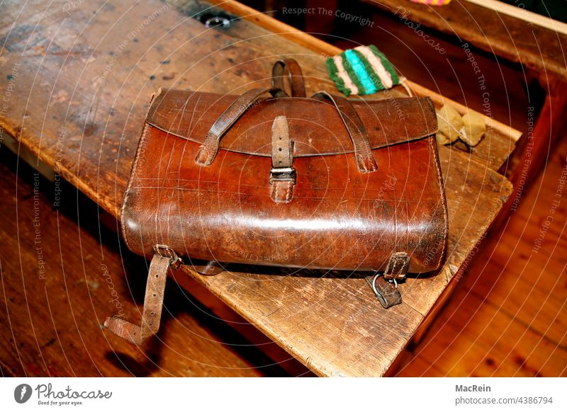 Old school desk from the 50s with satchel Satchel Table School desk Bag Inkpot Sponge Wooden table School bench vintage Brown nobody Copy Space then retro style