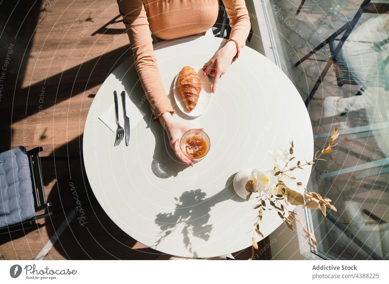 Anonymous Woman with coffee and croissant at table in cafe woman dessert delicious tasty drink beverage female french aromatic fresh enjoy beret pastry sweet