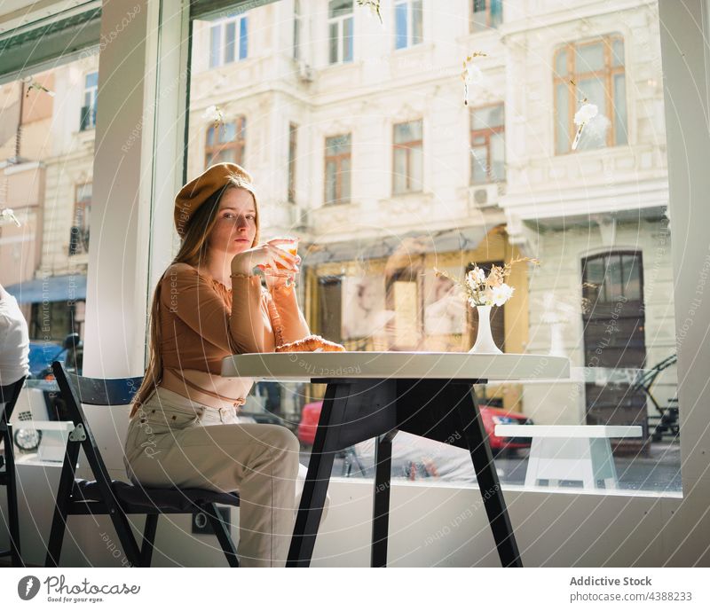 Woman with coffee and croissant at table in cafe woman dessert delicious tasty drink beverage female french aromatic fresh enjoy beret pastry sweet food