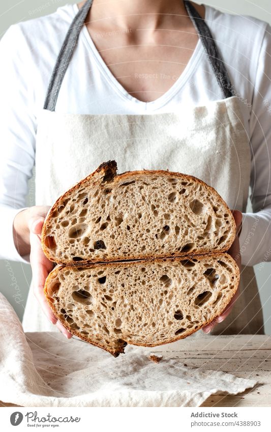 Hands holding freshly baked sourdough bread hand food rye healthy organic half grain woman baker delicious traditional soft flour tasty breakfast cereal natural