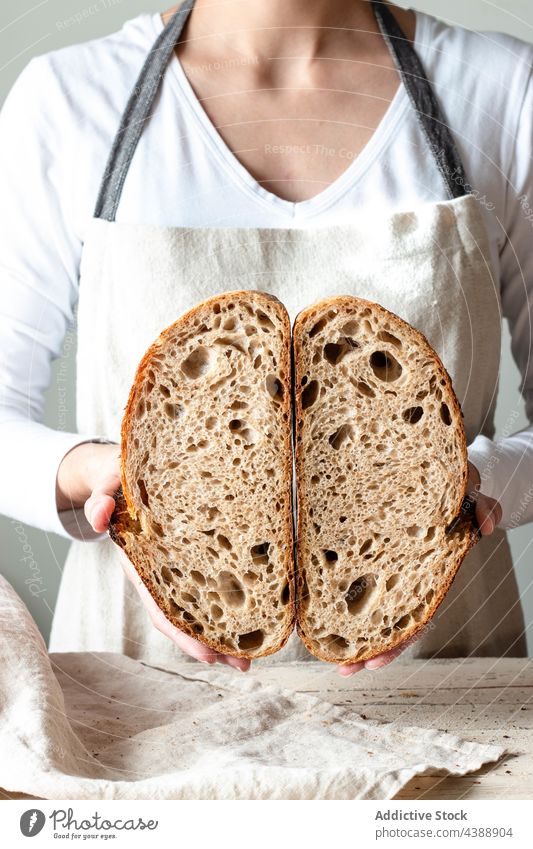 Hands holding freshly baked sourdough bread hand food rye healthy organic half grain woman baker delicious traditional soft flour tasty breakfast cereal natural