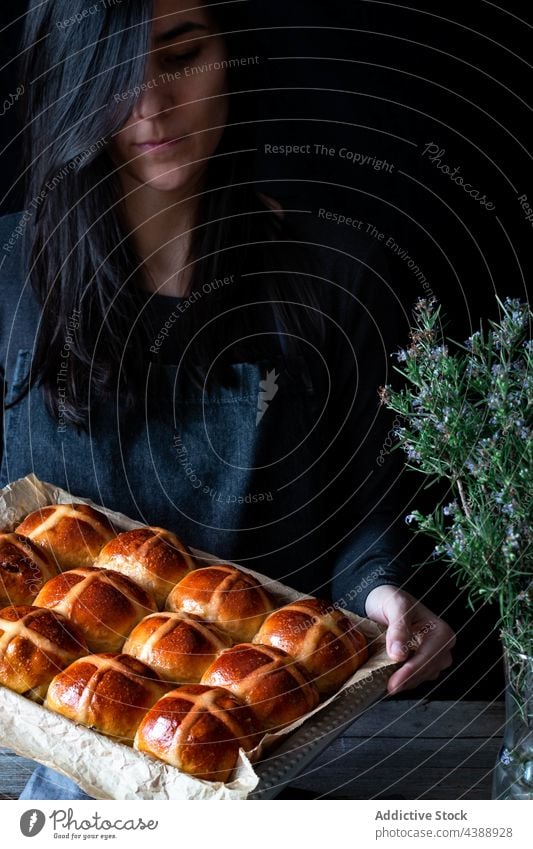 Woman holding hot cross buns woman glaze fresh puff baking tray food wheat baked soft grain flour baker bakery cereal organic breakfast dessert pastry sweet