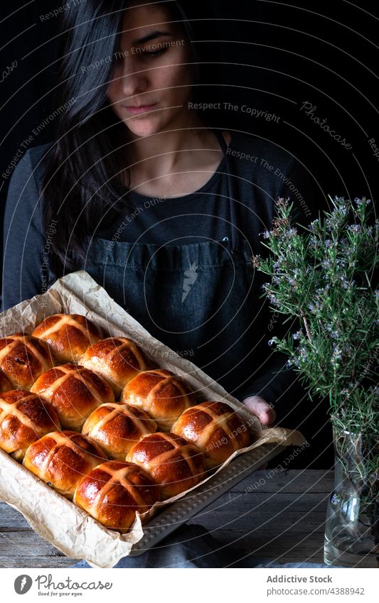 Woman holding hot cross buns woman glaze fresh puff baking tray food wheat baked soft grain flour baker bakery cereal organic breakfast dessert pastry sweet