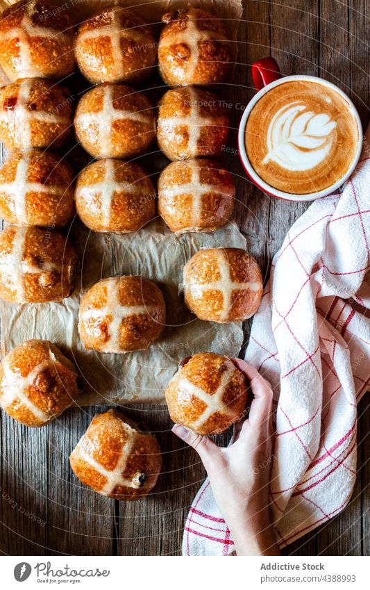 Freshly baked sourdough hot cross buns coffee hand fresh food glaze puff wheat soft grain flour bakery cereal organic breakfast dessert pastry sweet delicious