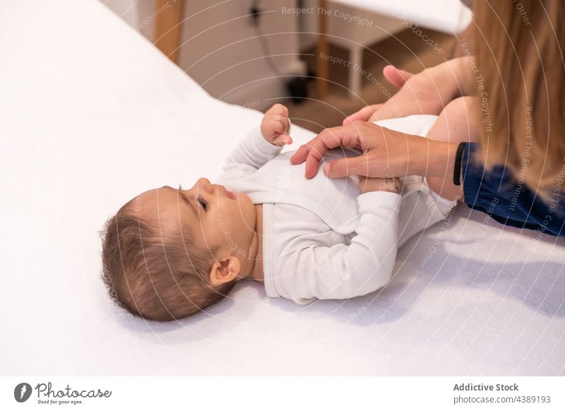 Baby during appointment in hospital with crop mother and doctor baby pediatrician check up visit infant examine diagnostic clinic patient job work professional