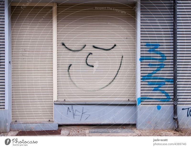 Good mood at the closed roller shutter Roller shutter Spray Storefront Store premises Smiley Street art Closed Entrance Comic door Facade Doormat