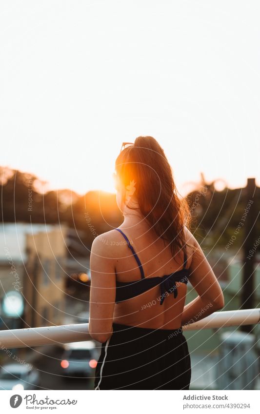 Woman enjoying sunset in city woman summer relax urban rest alone railing bridge calm sundown sunlight evening female tranquil peaceful serene contemplate