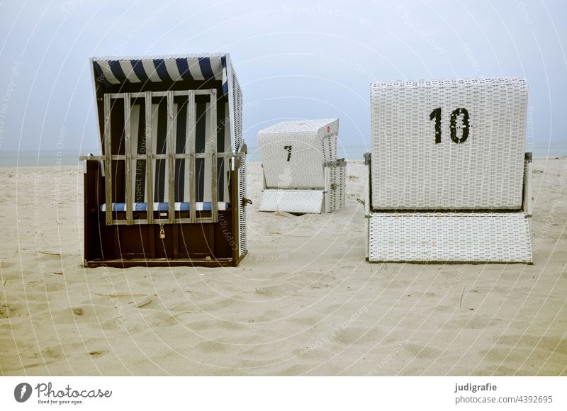 Three empty beach chairs at the Baltic Sea Beach Beach chair coast Sand Vacation & Travel Relaxation Tourism sieving ten figures Ocean Sky Calm Summer vacation