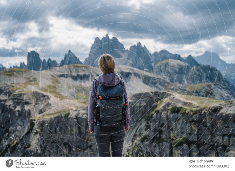 Woman hiker with backpack against Cadini di Misurina mountain group range of Italian Alps, Dolomites, Italy, Europe dolomites women cadini mountains amazing