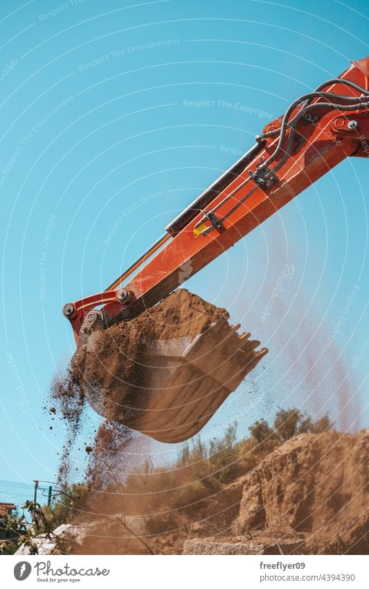 Closeup of a backhoe with dirt against sky Excavator shovel digging construction machinery heavy machinery construction site copy space working industry digger