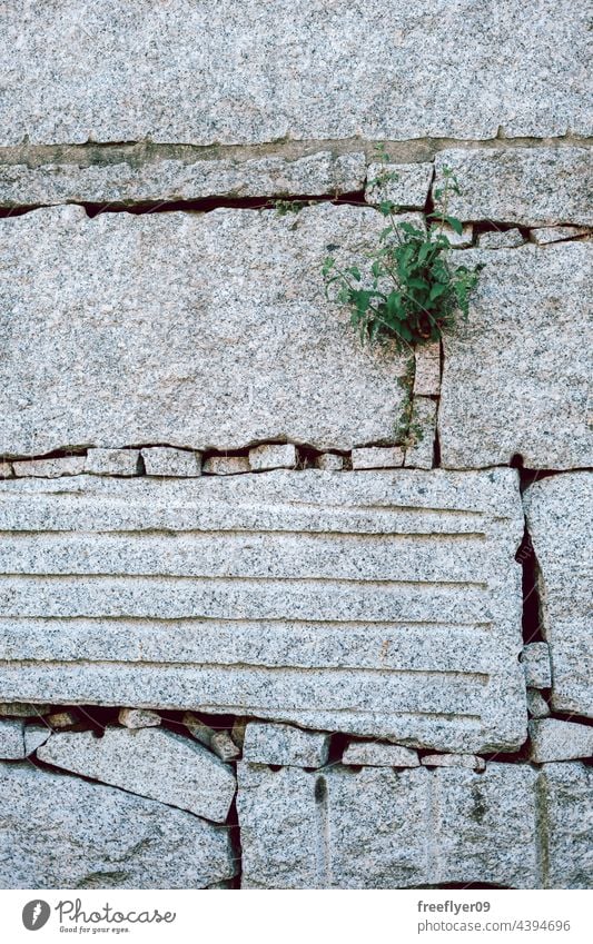 Wall made with big granite rocks texture wall sunlight embossed construction weathered material natural cracked pattern structure solid abstract detail