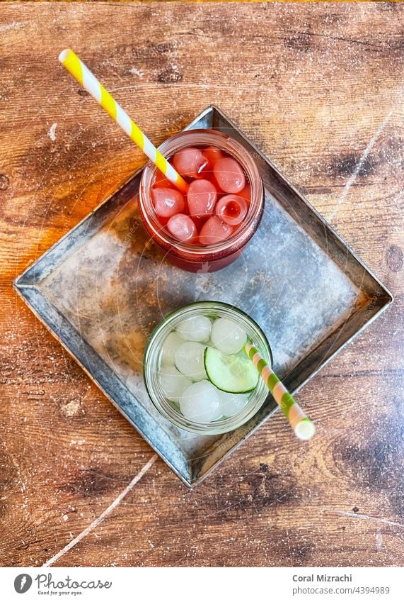 Breakfast drinks, Raspberry lemonade and cucumber lemonade on a wooden table, old town Prague, Czech Republic Lemon Lemonade Cucumber Drinking strew Summer Ice