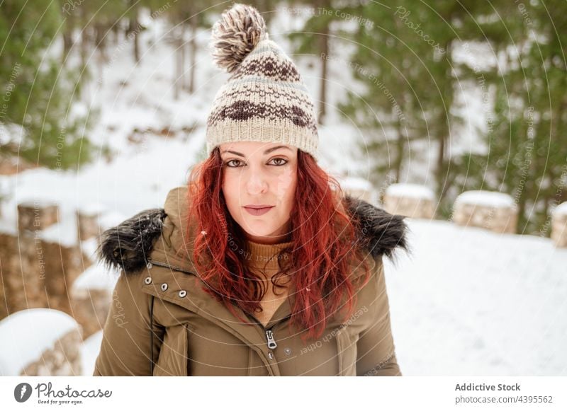 Woman in snowy winter woods woman warm clothes hat wintertime forest cold serene female nature woodland season frost peaceful appearance white outerwear