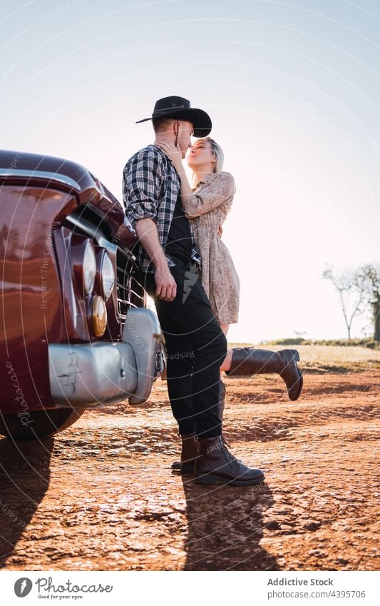 Stylish couple hugging near vintage car pick up retro embrace love old fashioned style vehicle countryside transport boyfriend auto automobile parked together