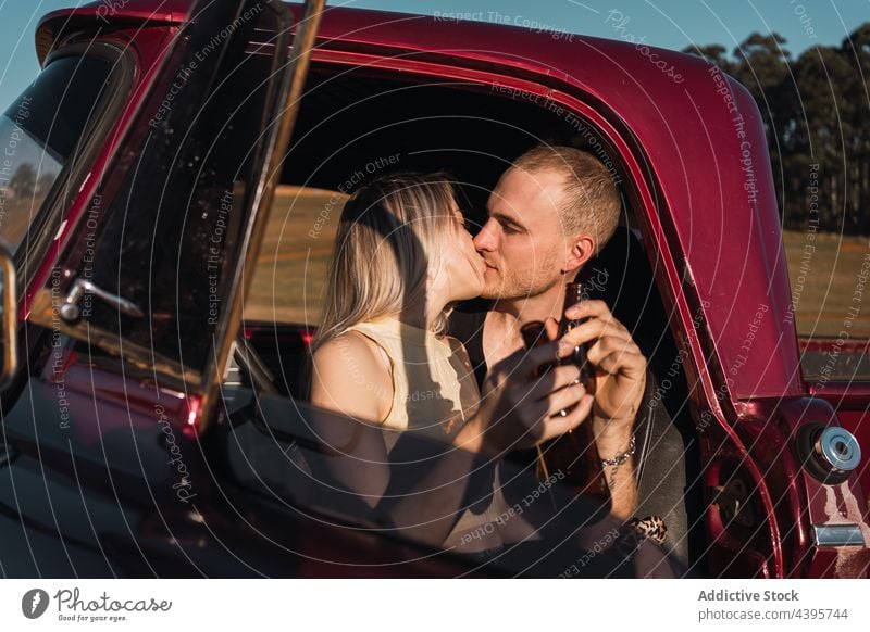 Loving couple kissing in retro car pick up vintage love embrace old fashioned summer relationship romantic hug valentine together bonding sit boyfriend