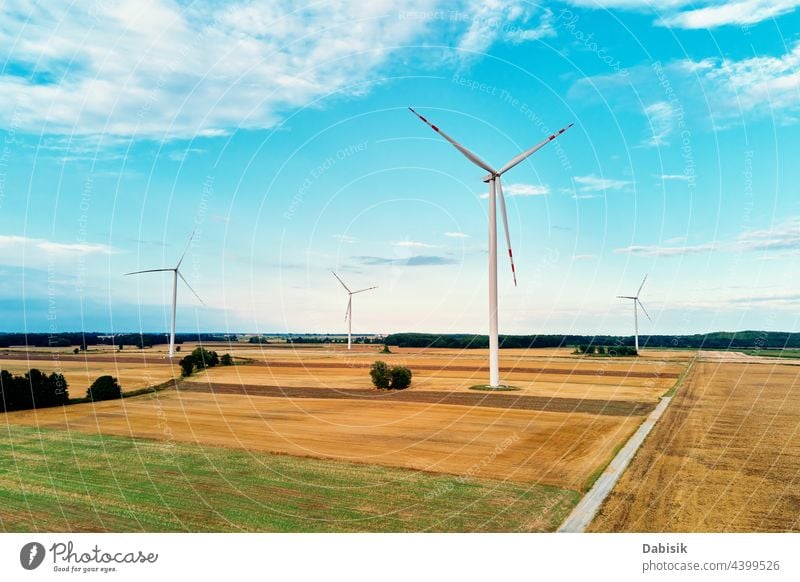 Windmill among agricultural fields. Wind turbine generator at summer day. Wind energy concept, Suistanable and renewable energy for climate protection windmill