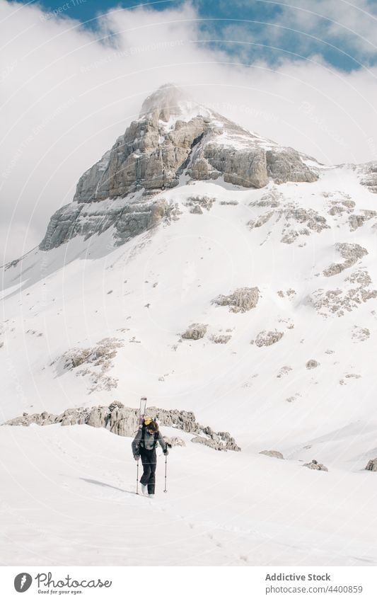 Unrecognizable skier on rough mount with snow in winter mountain pyrenees sport cloudy sky nature highland recreation athlete atmosphere air ridge weekend