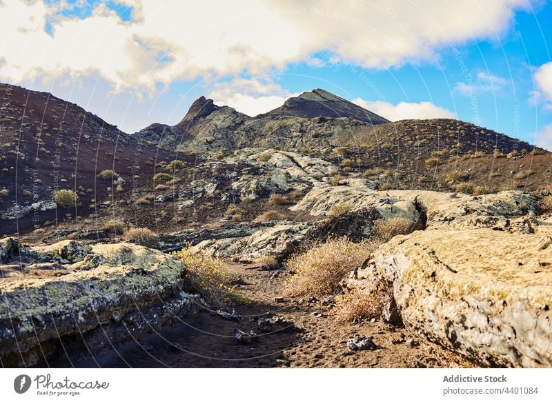 Rock formation near path in nature rock countryside rough summer surface highland cliff daytime fuerteventura spain canary islands stone mountain landscape