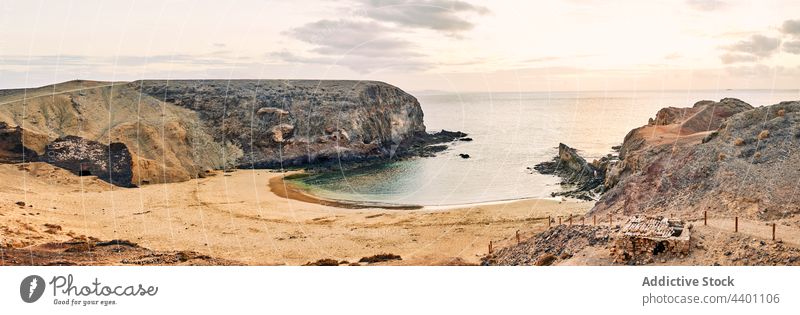 Calm bay with clean water in morning sea shore sky sunrise cloudy beach cliff fuerteventura spain canary islands nature coast ocean calm landscape scenic