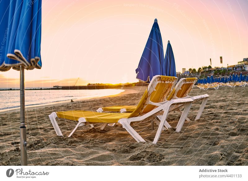 Loungers and umbrellas on beach at sundown lounger sunset resort vacation summer sea sand holiday fuerteventura spain canary islands seaside paradise relax