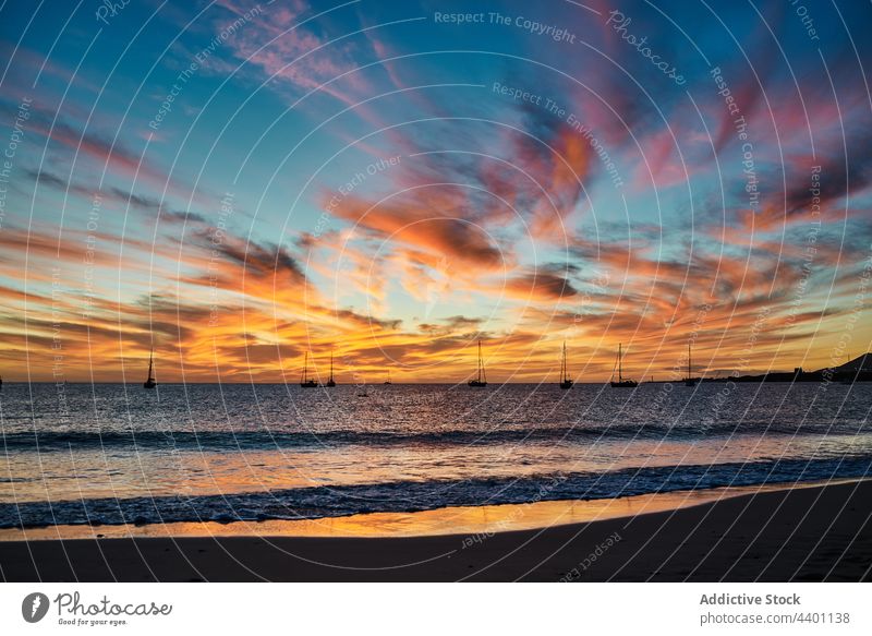 Bright sunset sky over sea water evening boat scenic weather bright cloudy fuerteventura spain canary islands picturesque sundown ocean nature dusk twilight